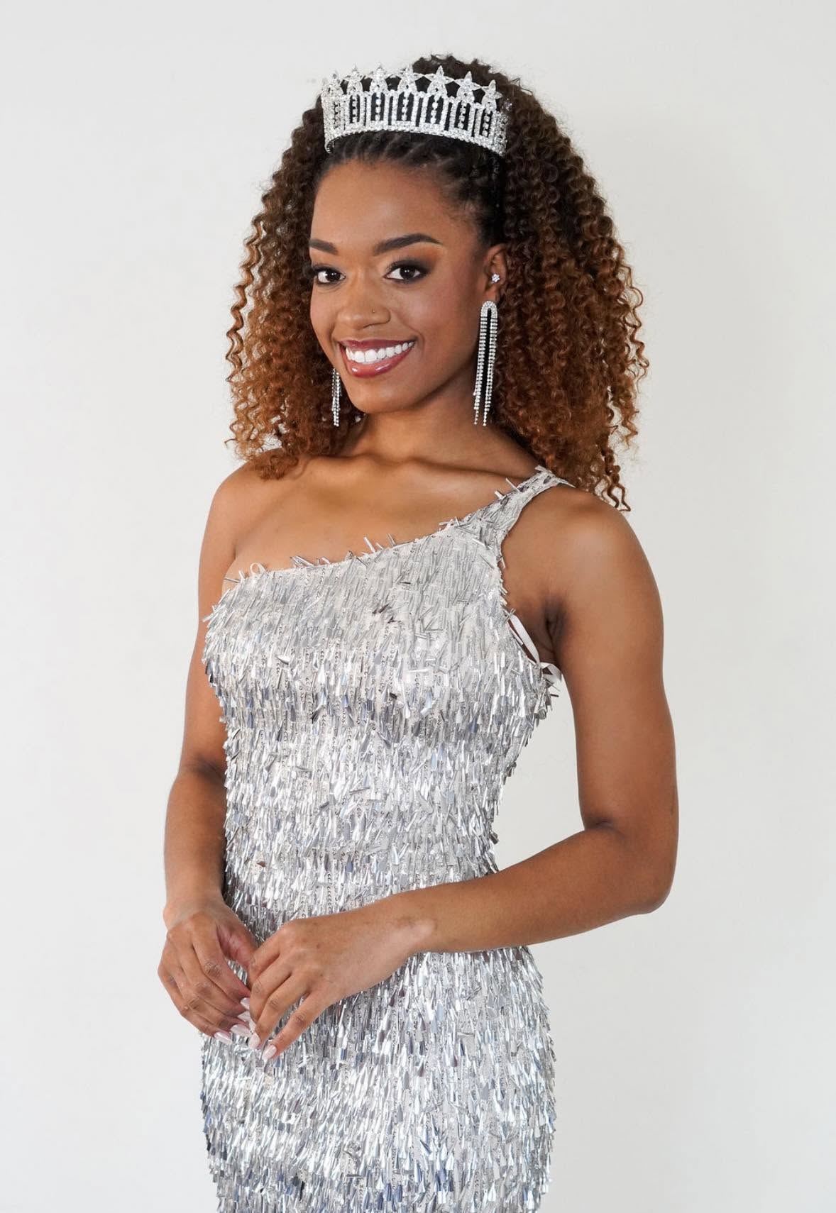 Miss ICT titleholder wearing her crown and a silver gown